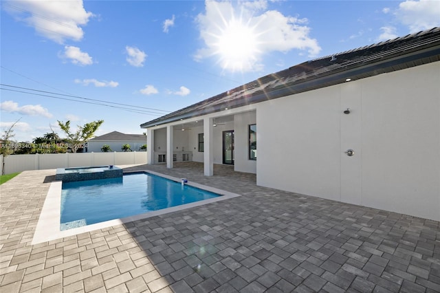 view of pool with an in ground hot tub and a patio