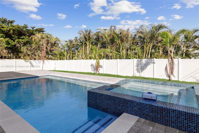 view of swimming pool with an in ground hot tub