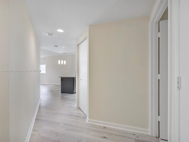 hallway with light wood-type flooring