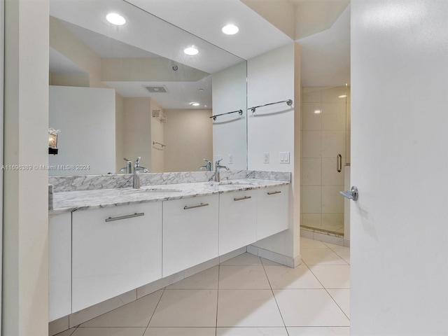 bathroom featuring tile patterned flooring, vanity, and walk in shower