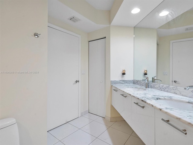 bathroom featuring tile patterned flooring, vanity, and toilet