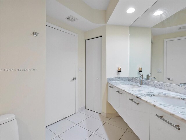 full bathroom featuring toilet, vanity, tile patterned floors, and independent shower and bath