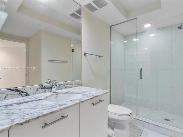 bathroom featuring vanity, toilet, and walk in shower