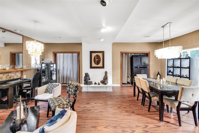 dining room featuring a notable chandelier and wood-type flooring