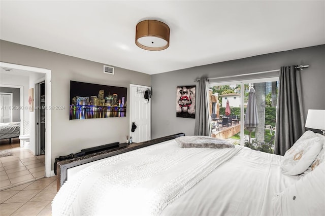 bedroom featuring access to exterior and light tile patterned flooring