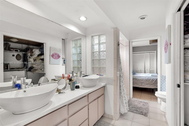 bathroom featuring tile patterned floors, vanity, and toilet