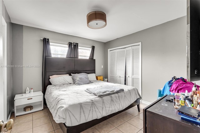 bedroom featuring a closet and light tile patterned floors