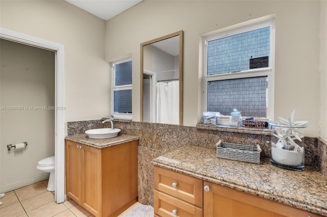 bathroom with tile patterned flooring, vanity, and toilet