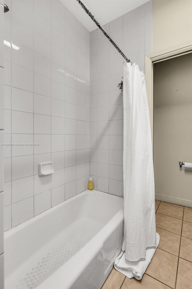 bathroom with tile patterned flooring and shower / bath combo