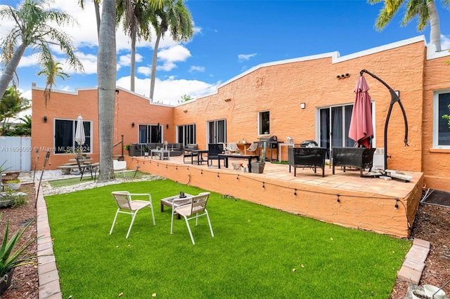 back of house featuring a patio and a lawn