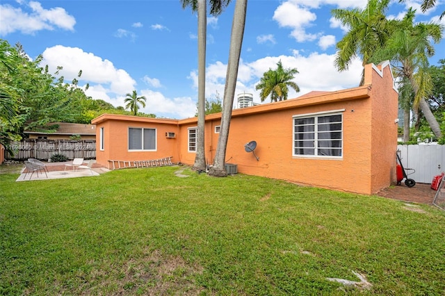 back of house featuring a patio area, a yard, and central AC unit