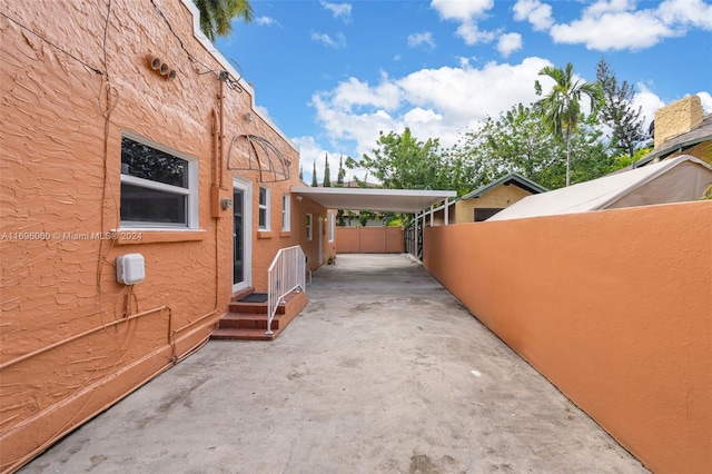 view of side of property featuring a carport