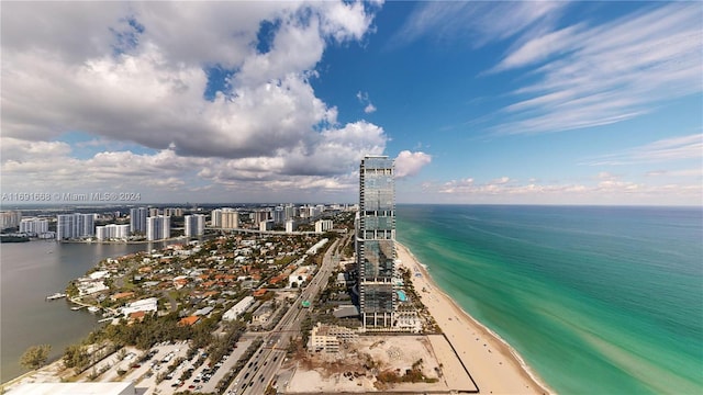 birds eye view of property featuring a water view and a view of the beach