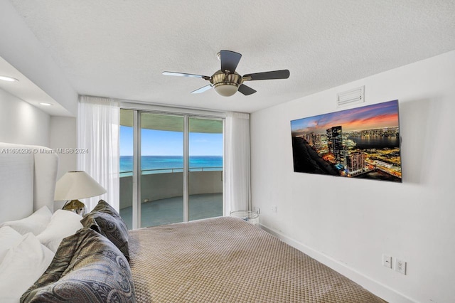 bedroom with carpet flooring, floor to ceiling windows, a textured ceiling, access to outside, and ceiling fan