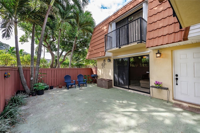 view of patio featuring a balcony