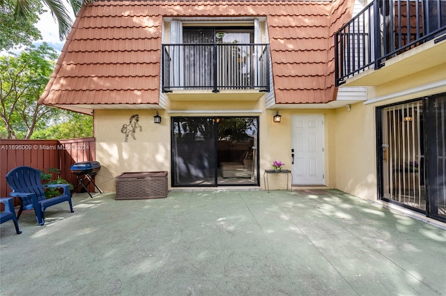 exterior space with a balcony and a patio