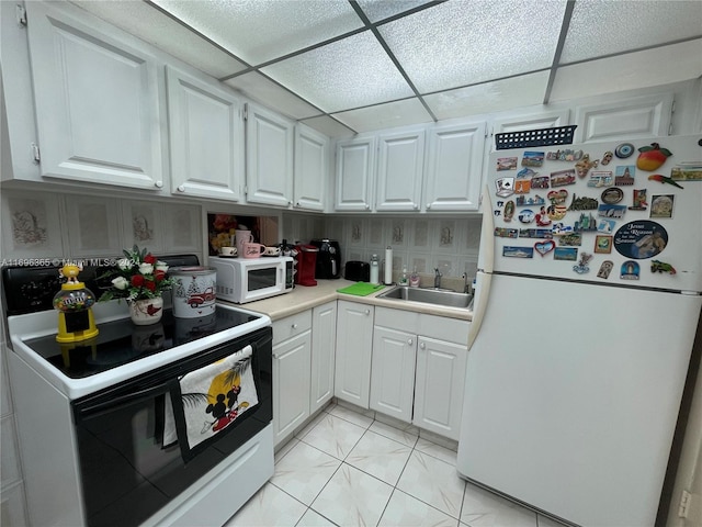 kitchen featuring sink, white cabinets, and white appliances