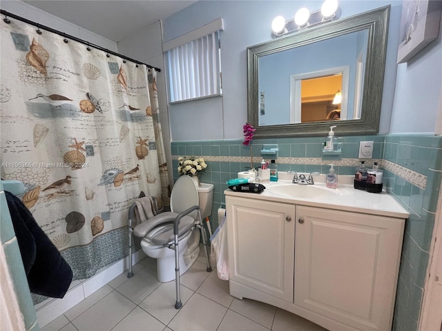 bathroom featuring tile patterned floors, a shower with curtain, vanity, tile walls, and toilet