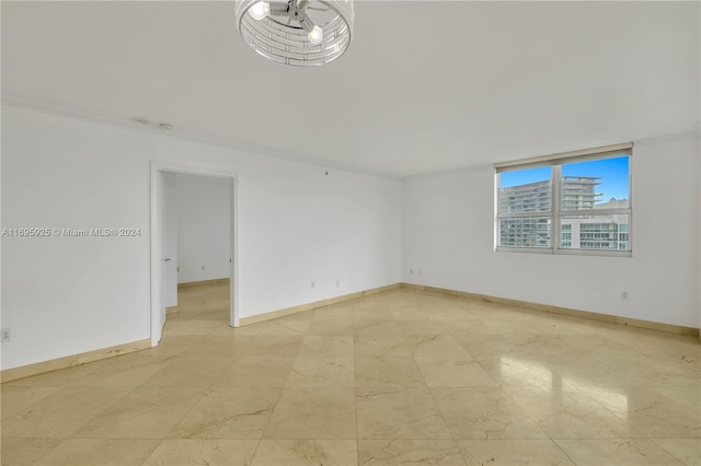 spare room featuring ornamental molding