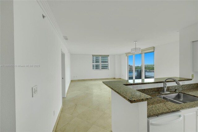 90 Alton Rd Unit 1902, Miami Beach, FL 33139 - kitchen featuring a sink, dishwasher, dark stone countertops, ornamental molding, and open floor plan