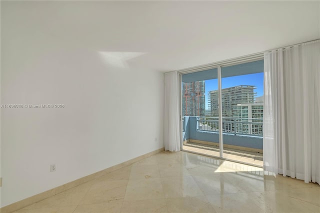 90 Alton Rd Unit 1902, Miami Beach, FL 33139 - unfurnished room featuring baseboards and expansive windows