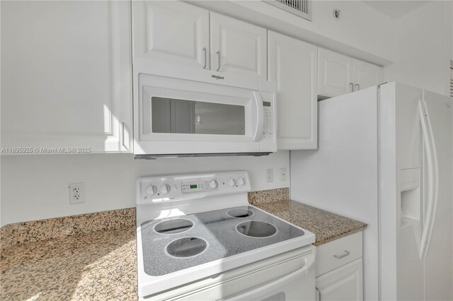 kitchen featuring white cabinets and white appliances