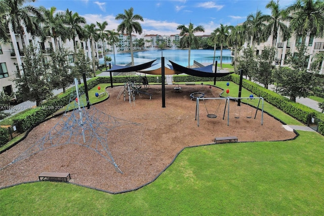 view of property's community with a playground and a water view