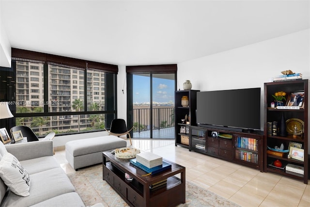 living room with expansive windows and light tile patterned floors