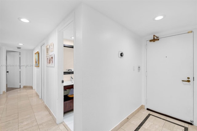 hallway featuring light tile patterned floors