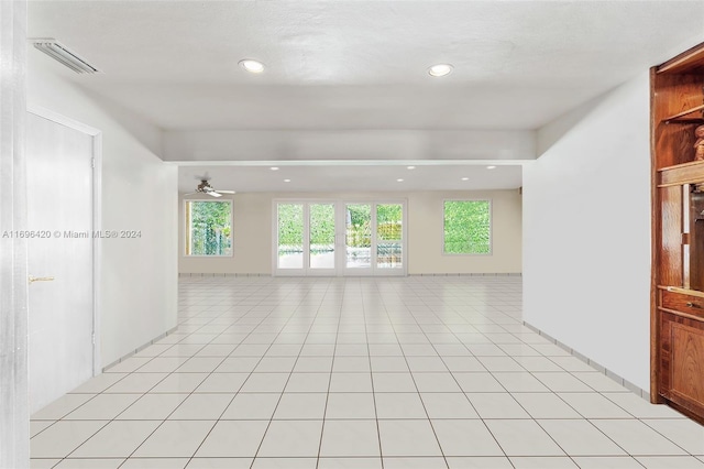 tiled empty room with ceiling fan