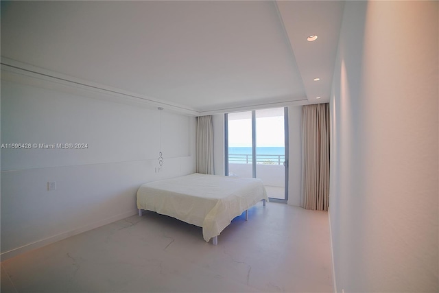 bedroom featuring a water view and access to outside