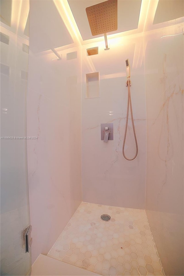 bathroom with a tile shower