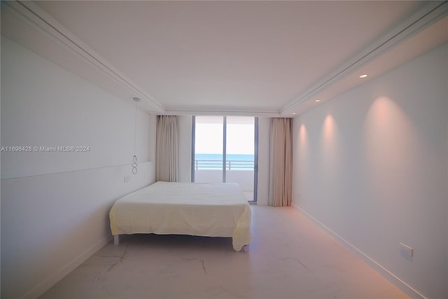 bedroom with a water view, a wall of windows, and ornamental molding