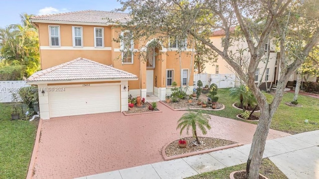 mediterranean / spanish house with a garage and a front lawn