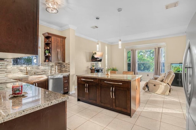 kitchen featuring pendant lighting, decorative backsplash, light tile patterned floors, appliances with stainless steel finishes, and light stone counters