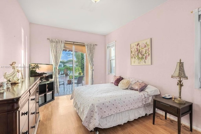 bedroom featuring light hardwood / wood-style floors and access to outside