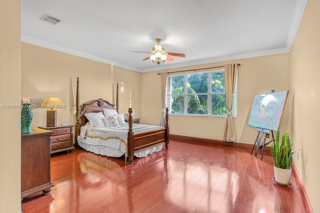 bedroom featuring hardwood / wood-style floors, ceiling fan, and crown molding