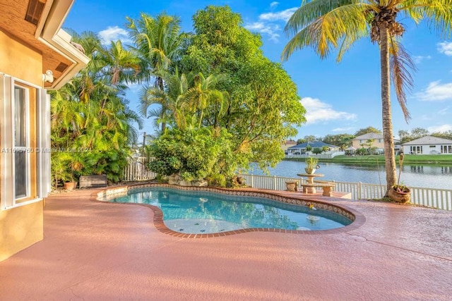 view of swimming pool with a patio and a water view