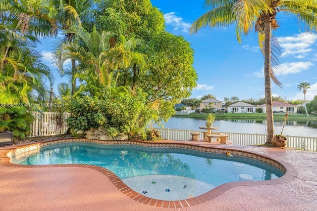 view of swimming pool featuring a water view and a patio area