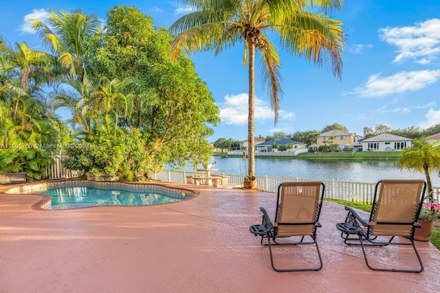 view of pool with a patio area and a water view