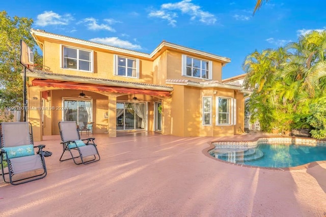 rear view of house with ceiling fan and a patio