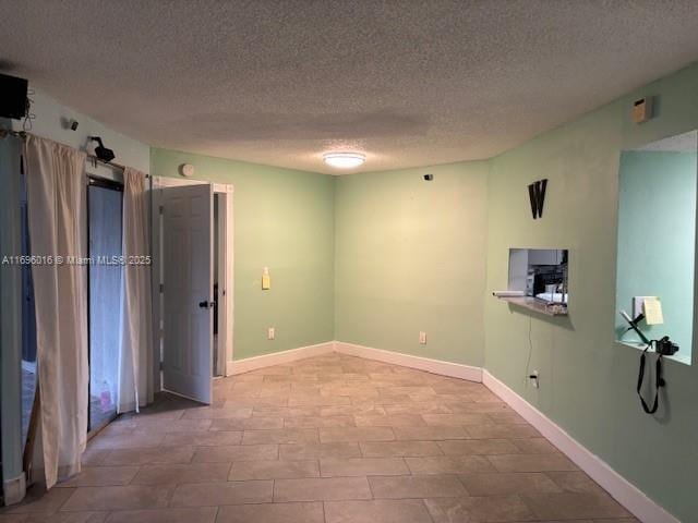 spare room with a textured ceiling