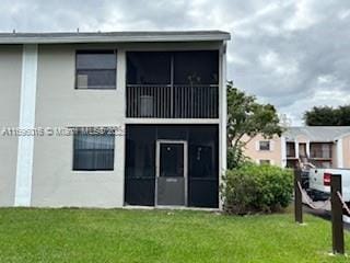 rear view of property with a lawn