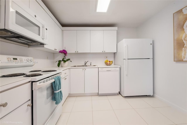 kitchen with white cabinetry, sink, light tile patterned flooring, and white appliances