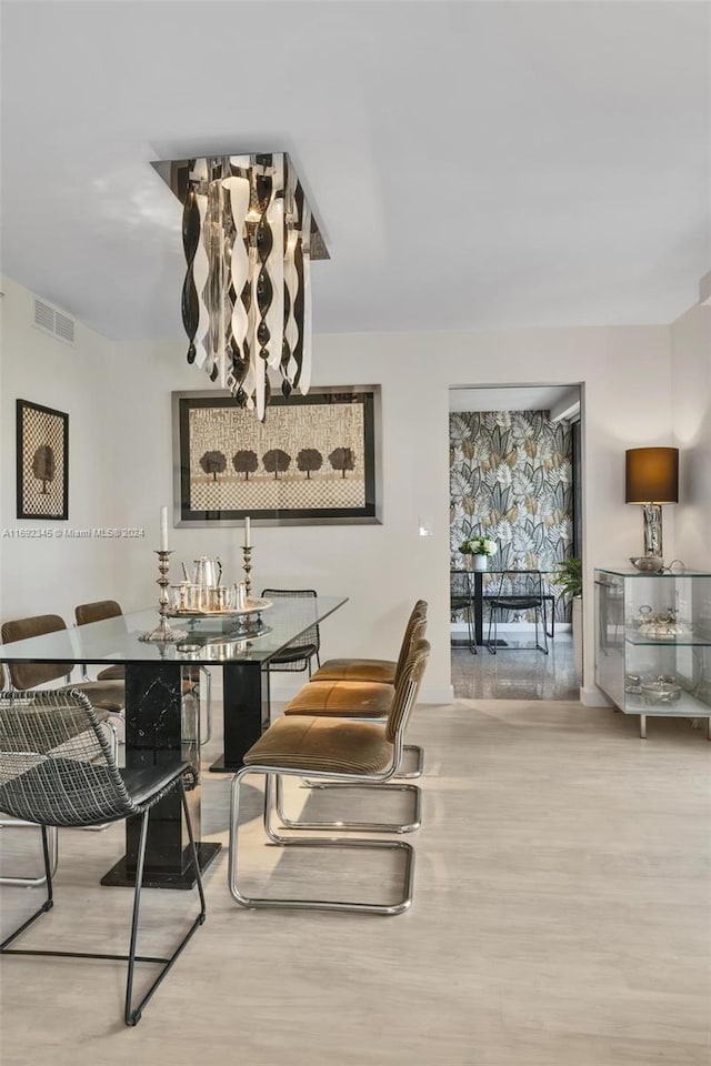 dining space with wood-type flooring