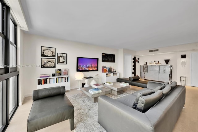 living room featuring plenty of natural light and light hardwood / wood-style flooring