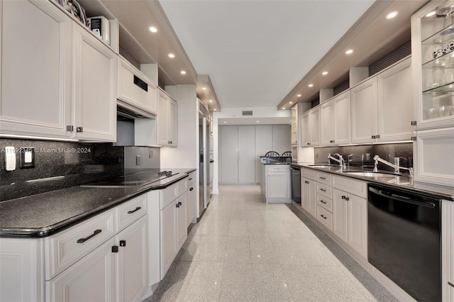 kitchen featuring decorative backsplash, white cabinetry, sink, and black appliances