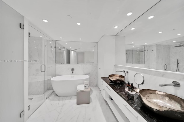 bathroom featuring vanity and shower with separate bathtub