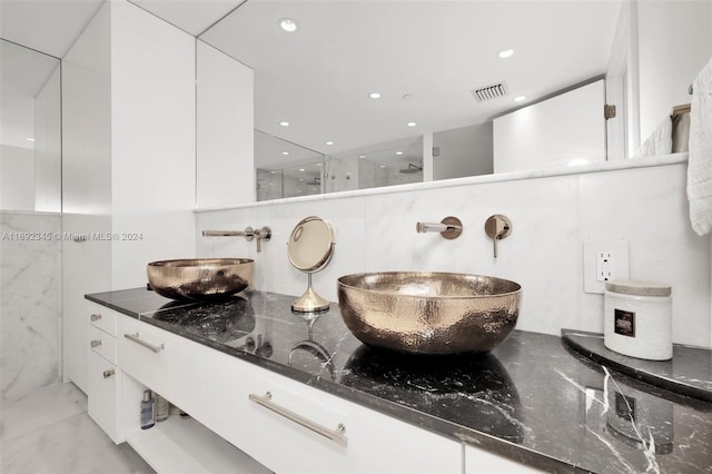 bathroom with vanity and a shower with shower door