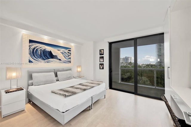 bedroom with access to exterior and light hardwood / wood-style flooring